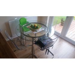 glass table and 4 perspex chairs