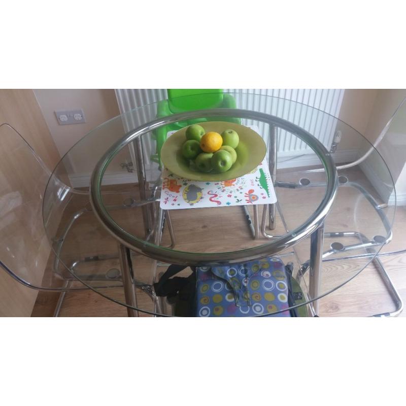 glass table and 4 perspex chairs