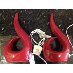 Two red bedside lamps with bulbs