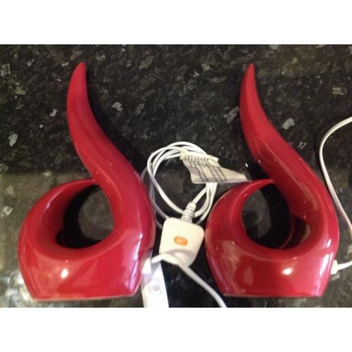 Two red bedside lamps with bulbs