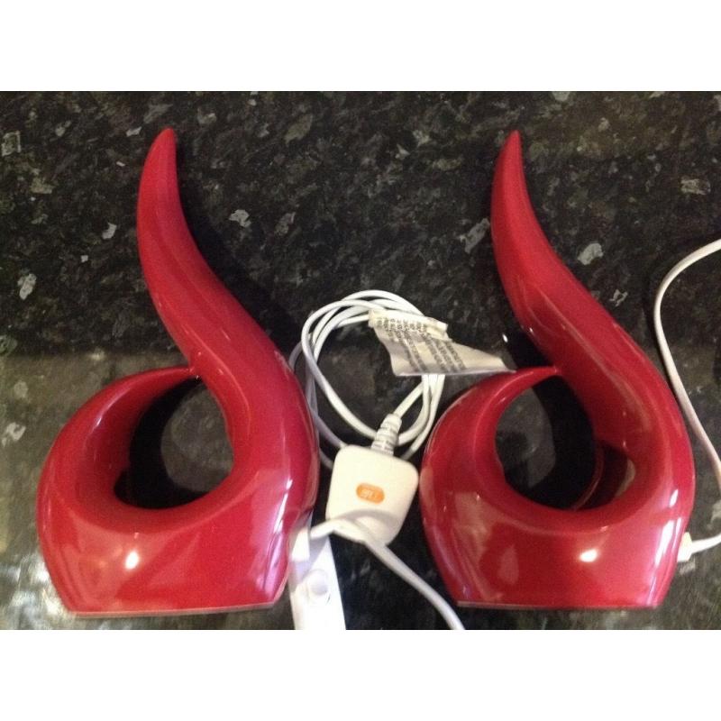 Two red bedside lamps with bulbs