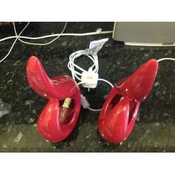 Two red bedside lamps with bulbs