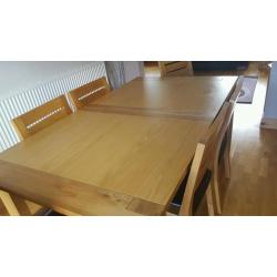 Dining room extending oak table and 6 oak with brown leather seat chairs