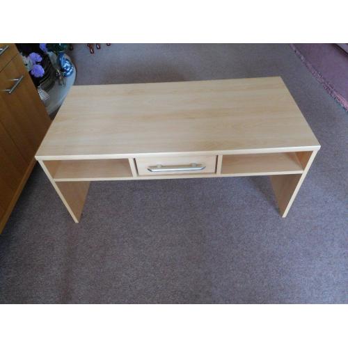 Long coffee table with shelves and drawer.