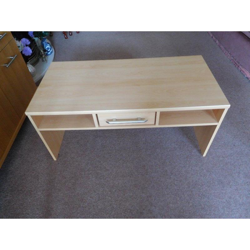 Long coffee table with shelves and drawer.
