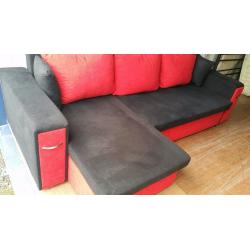 BLACK & RED CORNER SOFA BED WITH STORAGE & A MATCHING CHAIR FOR SALE.