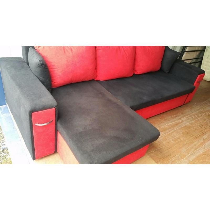 BLACK & RED CORNER SOFA BED WITH STORAGE & A MATCHING CHAIR FOR SALE.
