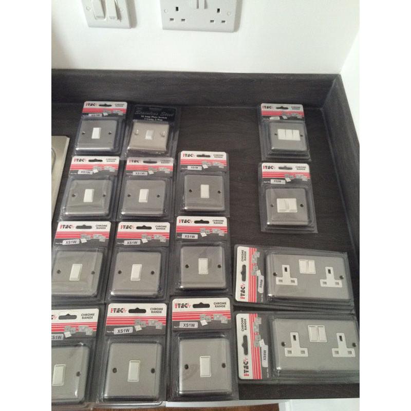 Box of brushed chrome electric switches by I-Tec
