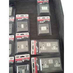 Box of brushed chrome electric switches by I-Tec