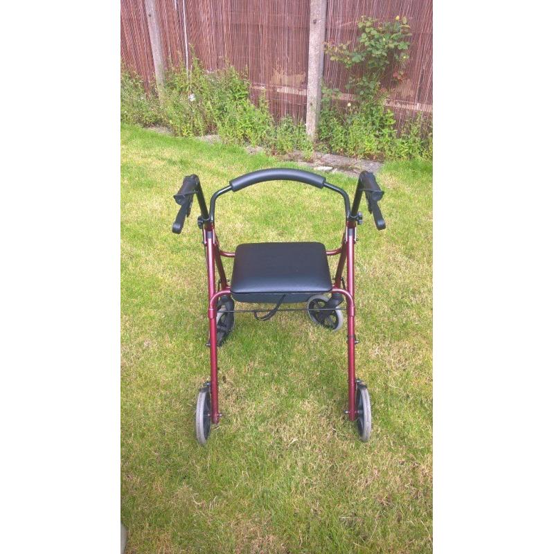 Four wheeled walking frame with seat and brakes