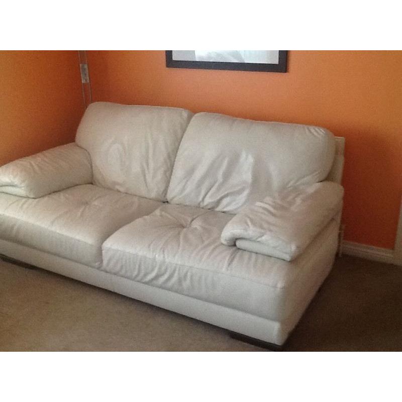 Two seater winter white leather sofa with foot stool
