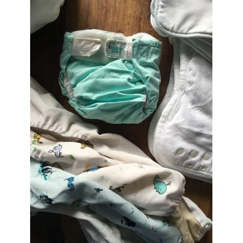 10 cloth nappies, 5 liners and assorted sizes of covers