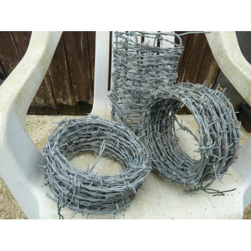 Three new rolls of barbed wire, length unsure.