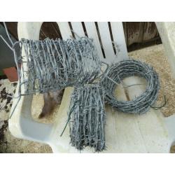Three new rolls of barbed wire, length unsure.