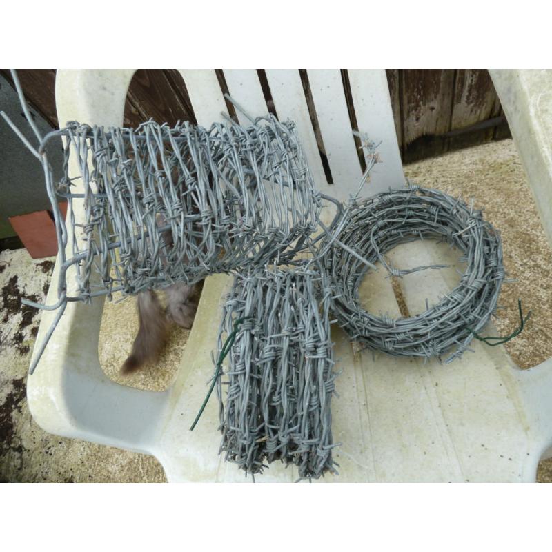 Three new rolls of barbed wire, length unsure.