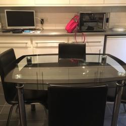 Glass dinning table and four chairs