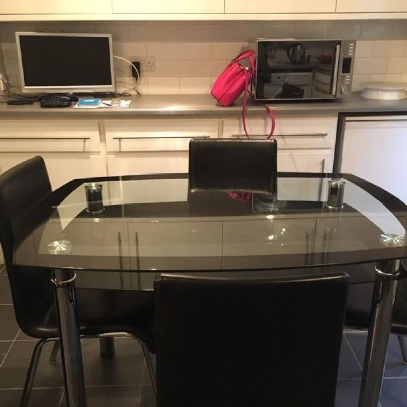 Glass dinning table and four chairs