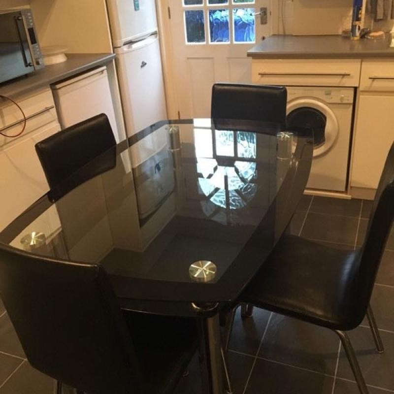Glass dinning table and four chairs