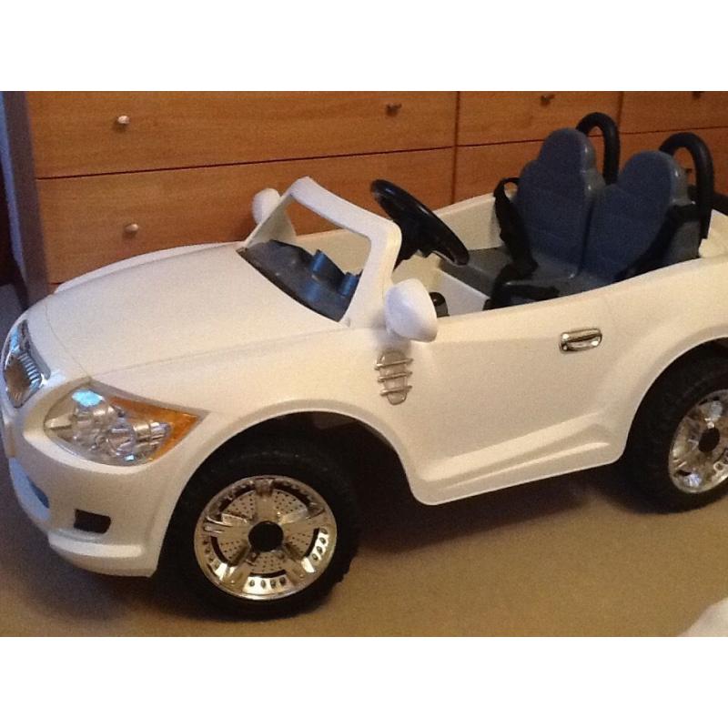 Childs 12v two seater car. White in colour.