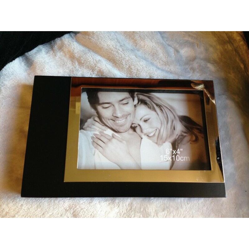 SILVER AND BLACK PHOTO FRAME NEW. PIC SIZES 15 CM BY 10 CM.